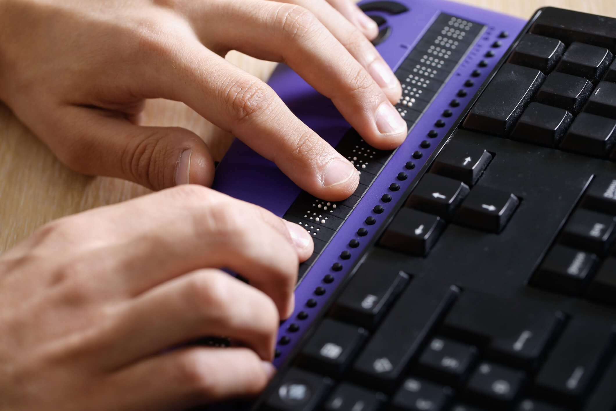 Person using braille keyboard