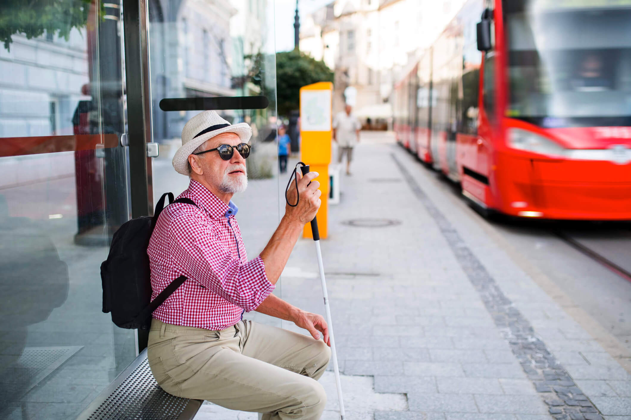 Blind man waiting for public transport