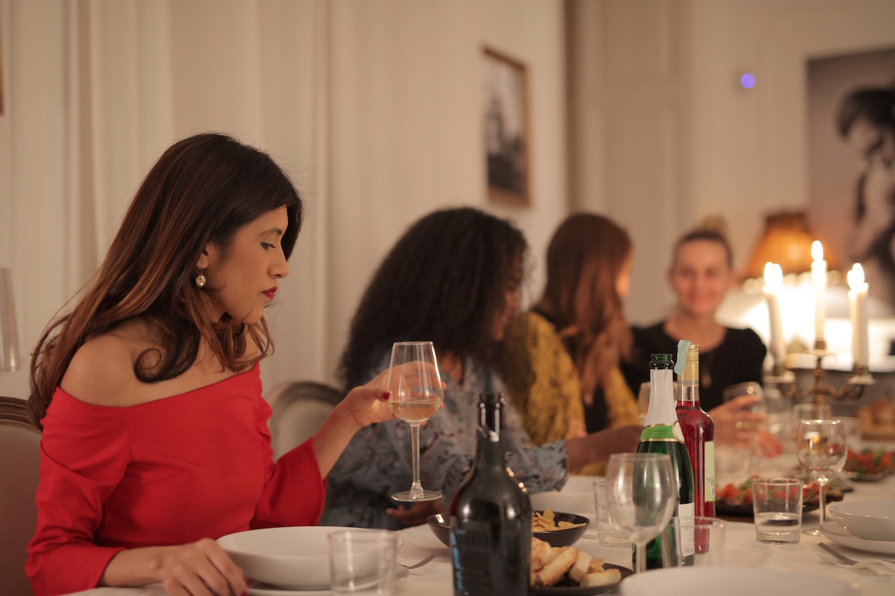 4 Women at a sophisticated dinner with wine