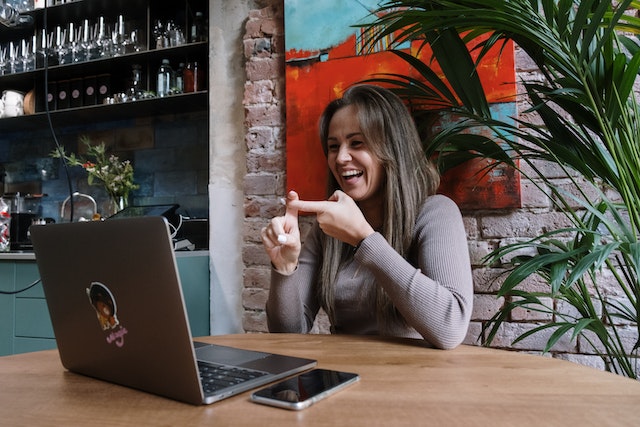 Women using AUSLAN infront of a laptop