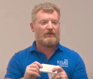 Screenshot of Dmitry pointing to rubber bumps on lower part of phone screen